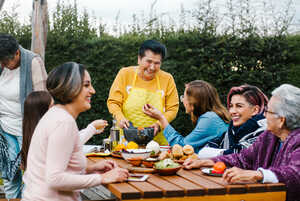 Multigenerational family enjoying a meal in the garden