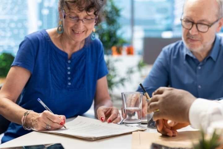 Mature woman signing an agreement