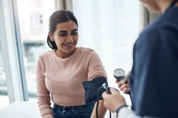 Woman having blood pressure check