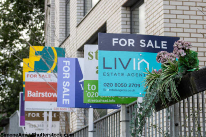 Estate agents' For Sale boards outside flats in the south of England