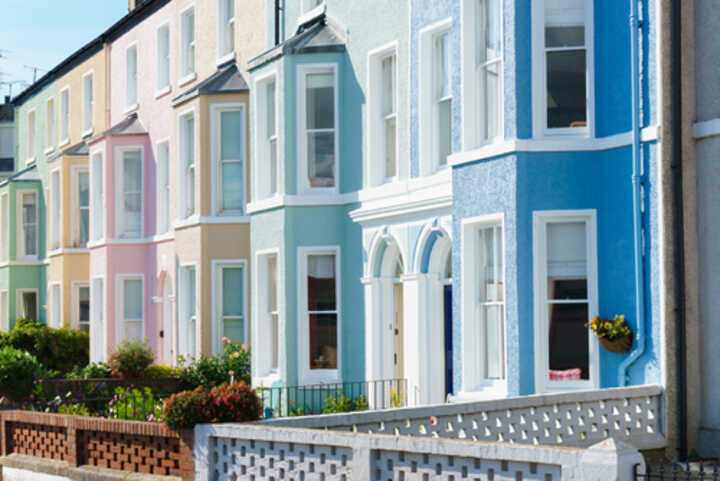 A row of Edwardian style terraced houses painted in pastel colours